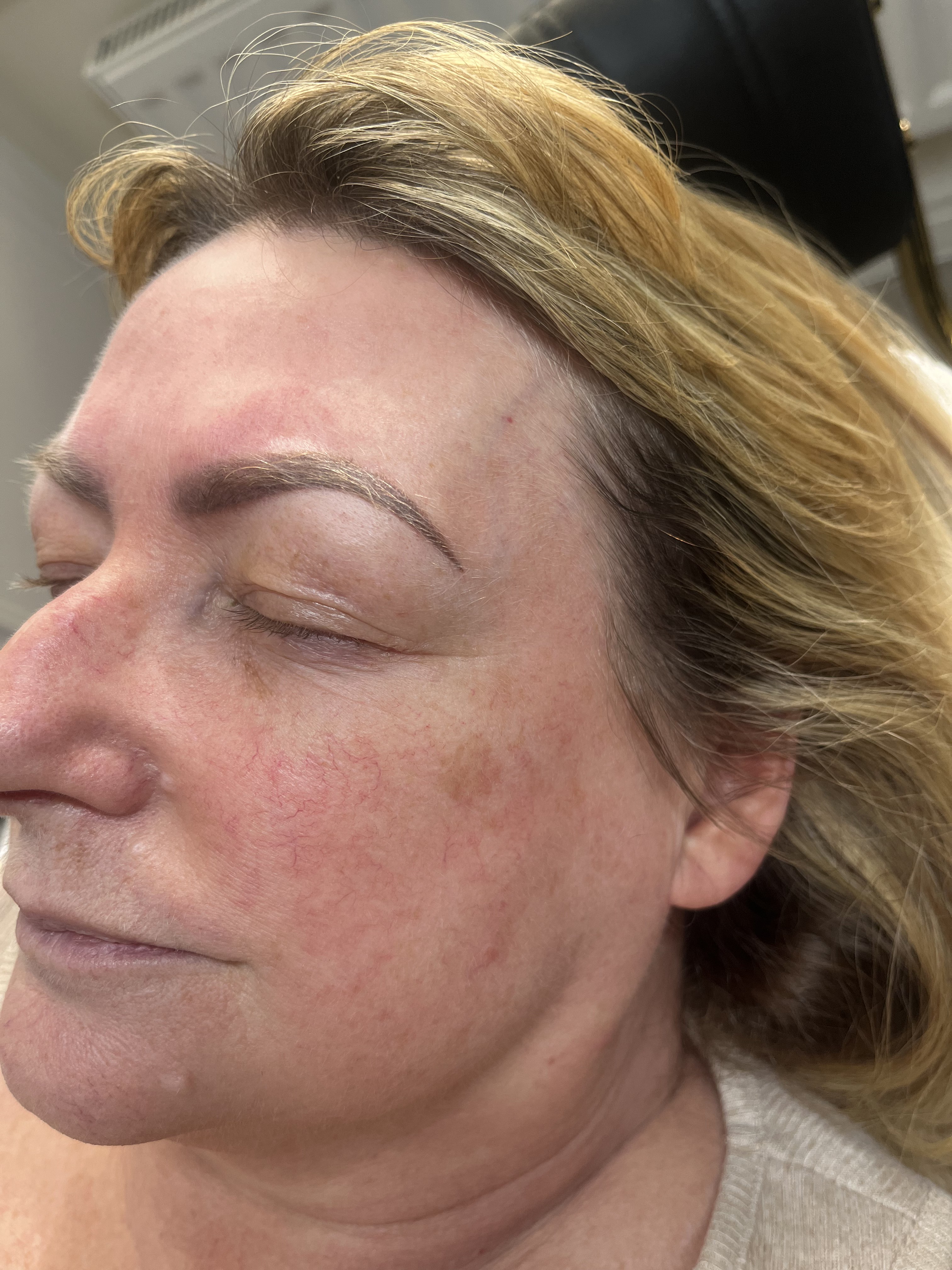 Close-up of faded semi-permanent brows before a refresh treatment