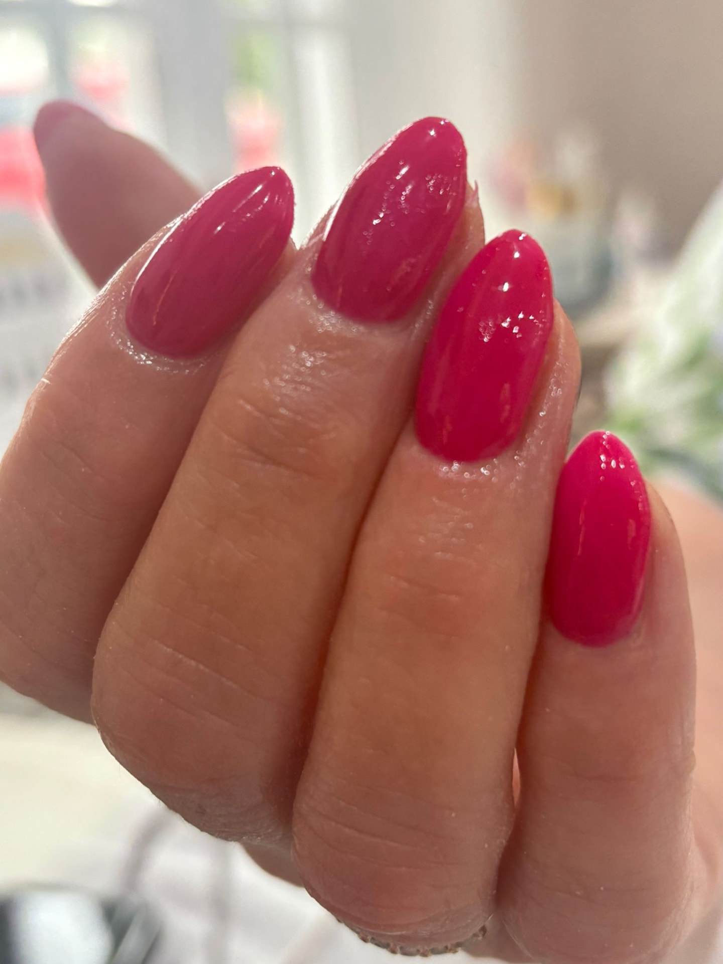 Long almond nails in glossy magenta pink