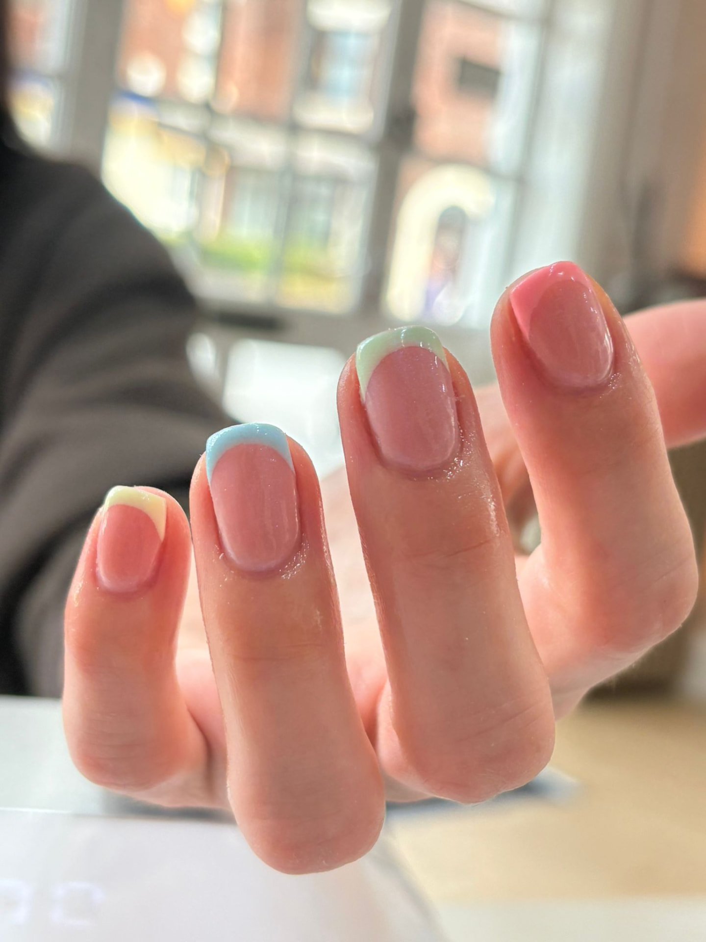 Colourful pastel French manicure tips in yellow, blue, green and pink