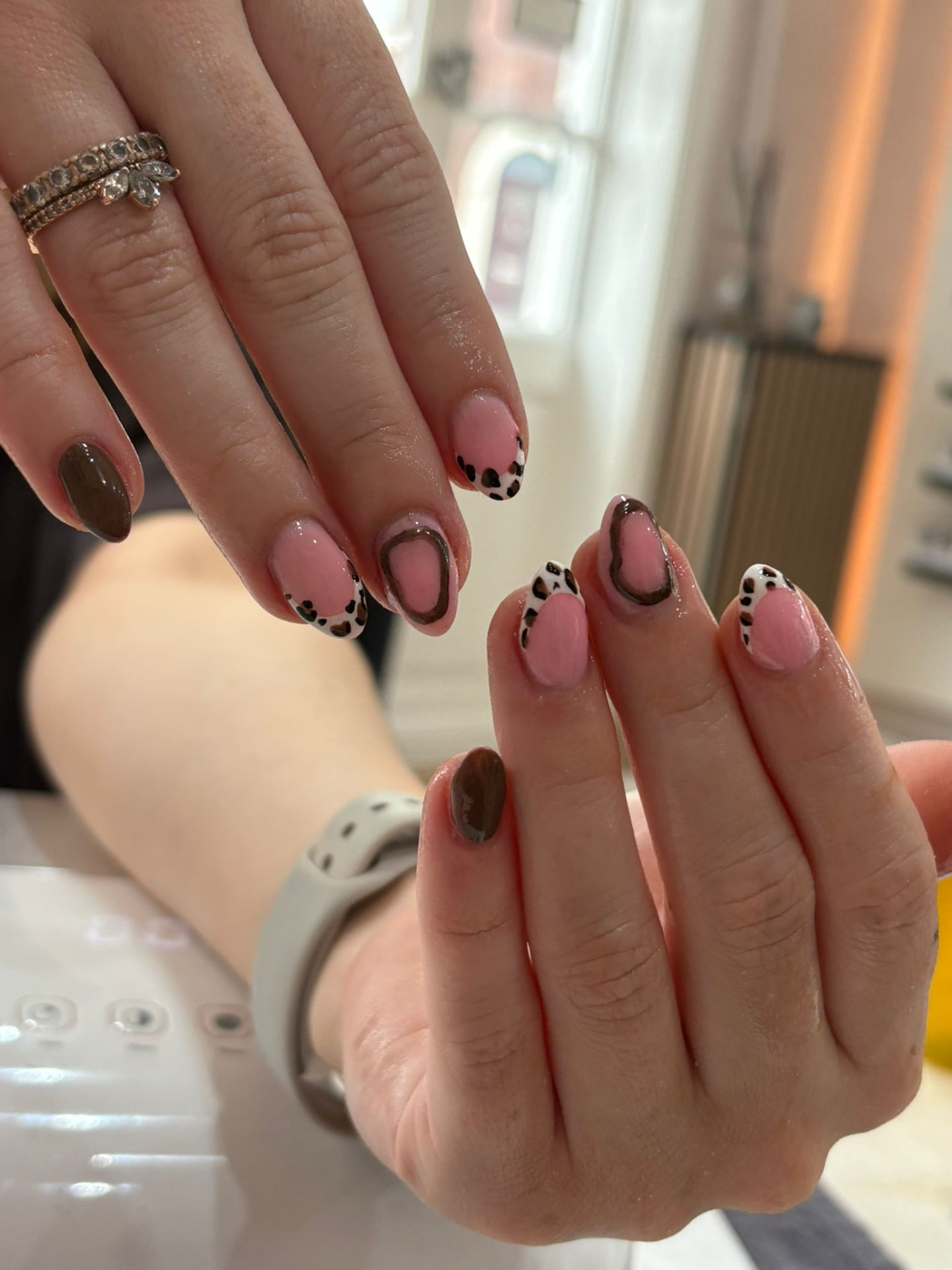 Leopard print nail art with brown and pink designs